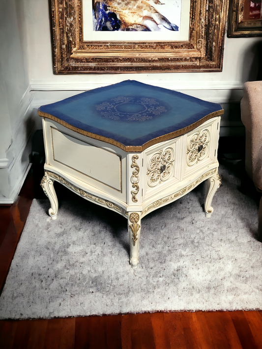 Italian coffee table with carved details and gold leaf decoration.
